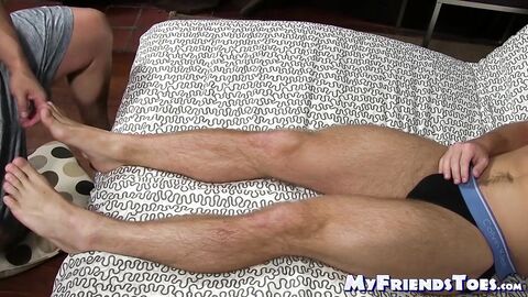 Hunk jerks his dick off while another man licks his feet