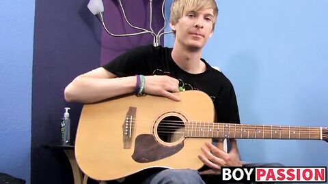Young man plays guitar before dick stroking and cumming