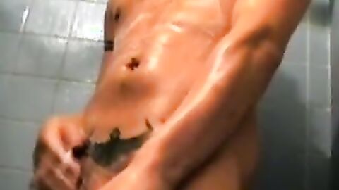 Amateur tattooed twink with a tan showers in classics porn