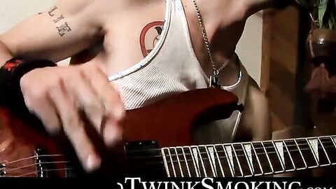 Straight rocker Axel plays his guitar and his throbbing cock with his pack of cigaret