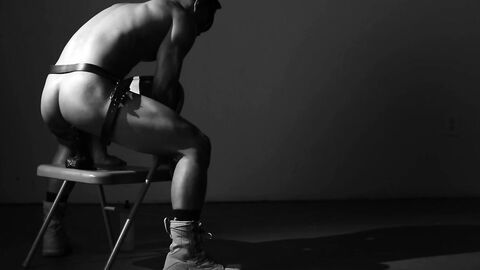 Horny Caged Jock equips belt with a massive dildo and strokes it slowly