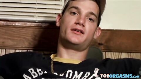 Handsome young man Glock rubbing his cock head on his sexy feet