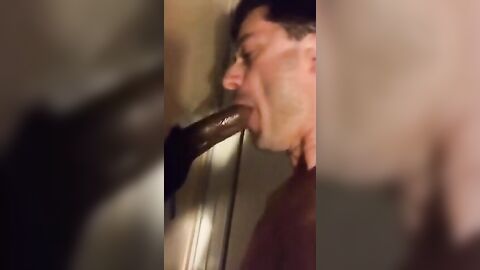Amateur sucks big black cock at glory hole