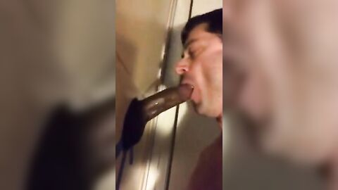 Amateur sucks big black cock at glory hole