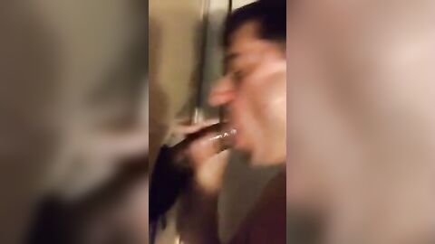 Amateur sucks big black cock at glory hole