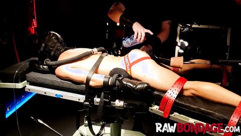 Chained jock lying face down being fisted in his ass