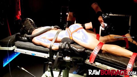 Chained jock lying face down being fisted in his ass