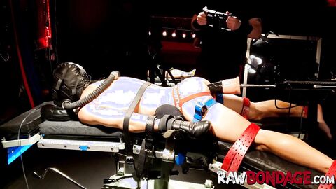 Chained jock lying face down being fisted in his ass