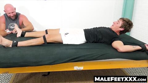 MaleFeetXXX.com - Logan N's wild wiggles in an intense tickle torture by hunky Killia