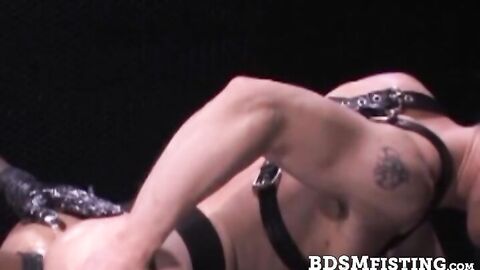 Quixote slips on a couple of black latex gloves, shines them up with creamy lube, and