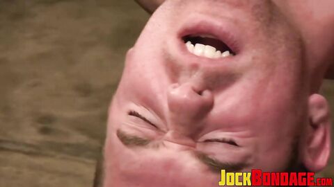 Alan Rhodes moans as the Master thrusts the giant rubber cock into his pucker