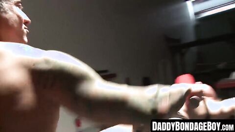 DaddyBondageBoy.com - Ball gagged hunk whipped while bound in leather during BDSM