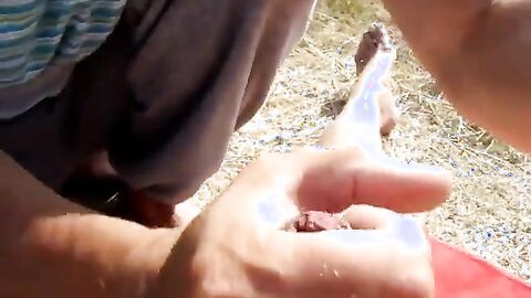 Old Man Blows Friend on Beach