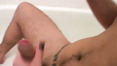 Dirty Tyler sits in the tub and starts jerking his thick uncut cock
