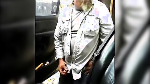 Bearded daddy strokes his cock by his truck outdoors.