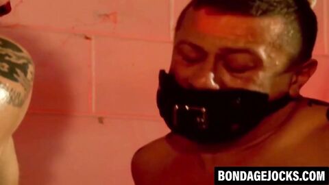 Muscular men are helpless while bound tightly together