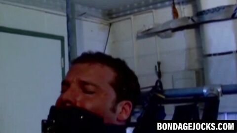 Muscular man can't scream as heavy chains hold him down