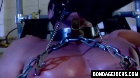 Muscular man can't scream as heavy chains hold him down