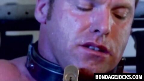 Submissive man struggles in chains and gets dominated