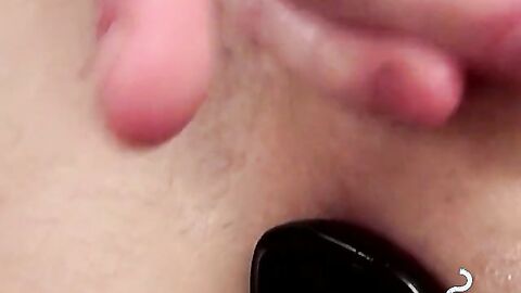 Attractive twink jerks off huge dick while blowing smoke