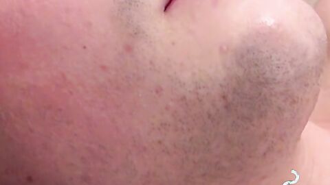 Attractive twink jerks off huge dick while blowing smoke