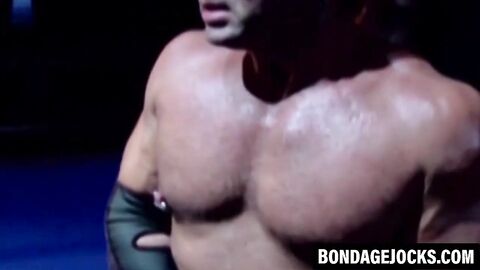 Wrestler dominates his lover while stroking his cock