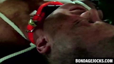 Handsome jock dominated after sweaty gym bondage session