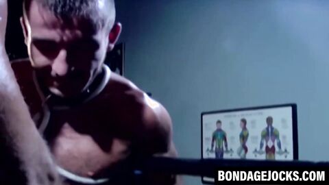 Tattooed wrestler bound and dominated by a fierce opponent