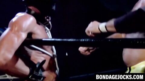 Tattooed wrestler bound and dominated by a fierce opponent