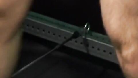 Bigg Pete struggles against chains tied down to his balls