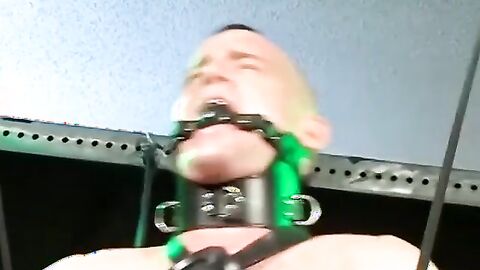 Bigg Pete struggles against chains tied down to his balls