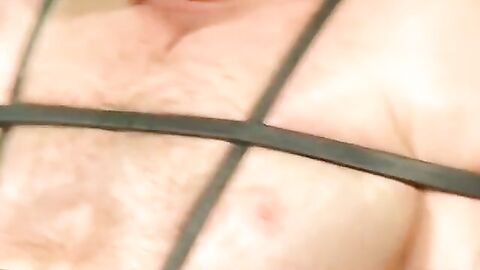 Bigg Pete roped down in chains with his mouth strapped shut