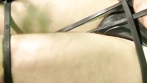 Bigg Pete roped down in chains with his mouth strapped shut