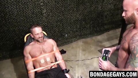 Muscular hunk bound and tormented in hardcore BDSM play