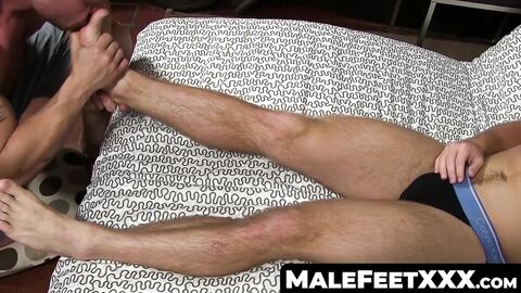MaleFeetXXX.com - Hunk jerks off while another man licks his feet