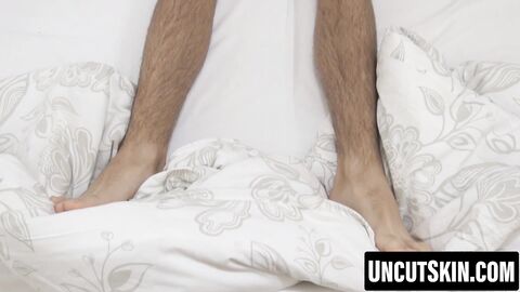 Twink teases his uncut tip before an explosive climax