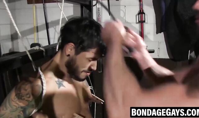 Inked hunk suffers agonizing nipple torment in pitch black