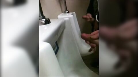 two slim dicks getting wanked at the urinals