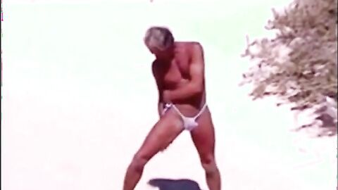 Tanned guy on beach in tiny string thong (temporarily!)