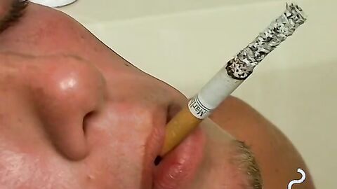 Christian wanks long dick while smoking in the tub
