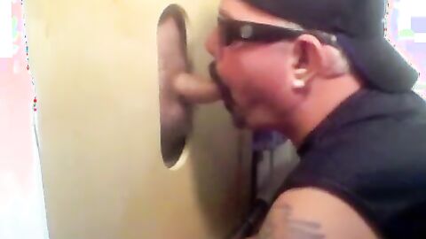 Two hot visitors take turns for a hot glory hole blowjob