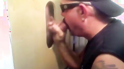 Two hot visitors take turns for a hot glory hole blowjob