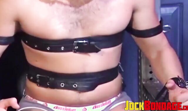 Man with muscles is restrained while only in his underwear