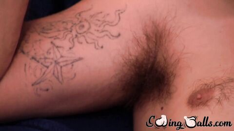 Hairy gay with shaved balls strokes cock while watching porn