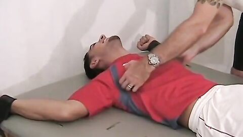 Ticklish and sexy soccer player is bound on the table