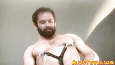 Hairy gay man strokes his fat cock in fetish retro clip