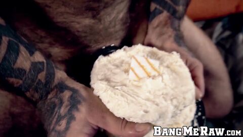 Inked hairy hunk jerks off and shoves his big cock in cake
