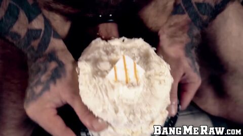 Inked hairy hunk jerks off and shoves his big cock in cake
