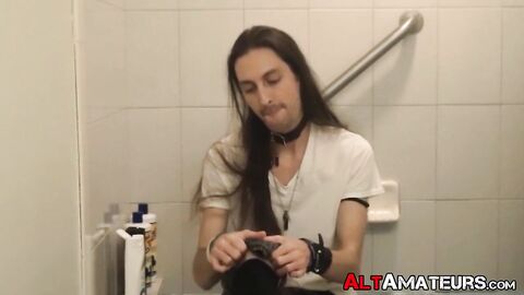 Long haired stud working on his cock on the bathtub