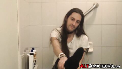 Long haired stud working on his cock on the bathtub